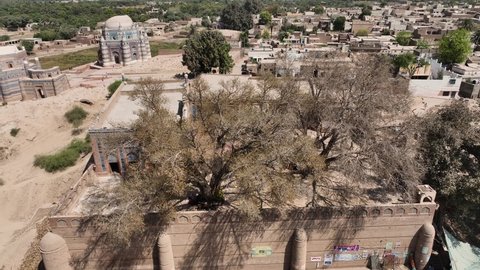 Punjab , Pakistan - 06 23 2022: Aerial View Of Jalaluddin Bukhari Tomb and Mosque At Uch Sharif In Pakistan. Circle Dolly Left