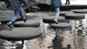 kids enjoy jumping on stone step.