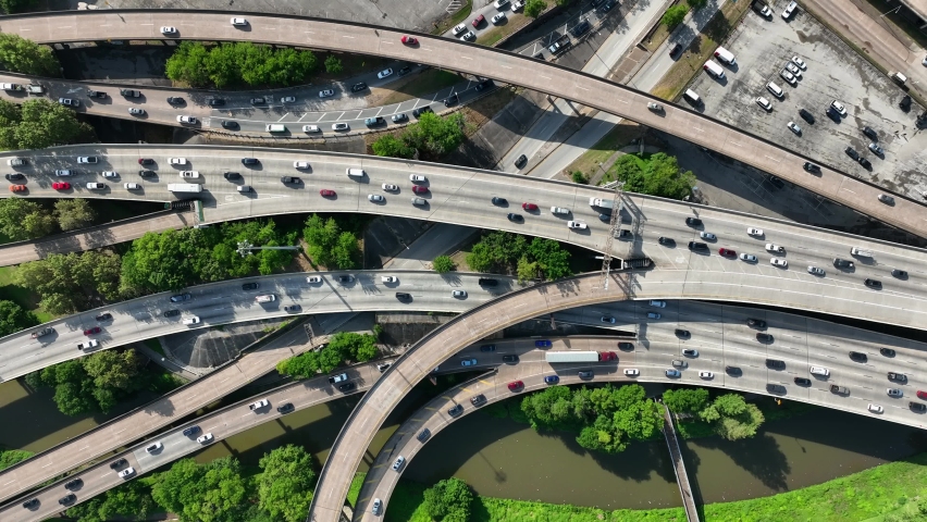Traffic in major metropolis in America. Cars driving on USA freeway system during rush hour. Top down aerial.