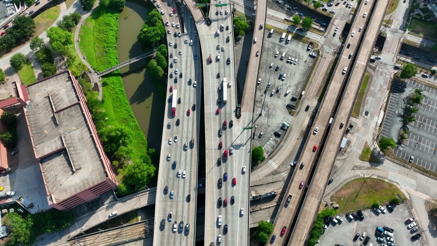 Downtown Houston interstate freeway traffic. Aerial reveal of skyline.