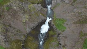 Waterfalls in Iceland that are stacked up with drone video moving down.