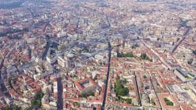 Inscription on video. Milan, Italy. Roofs of the city aerial view. Cloudy weather. Shimmers in colors purple, Aerial View