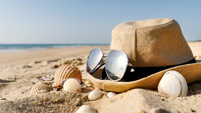 Hat, sunglasses on the beach- vacation or travel concept | Shutterstock HD Video #1091767961