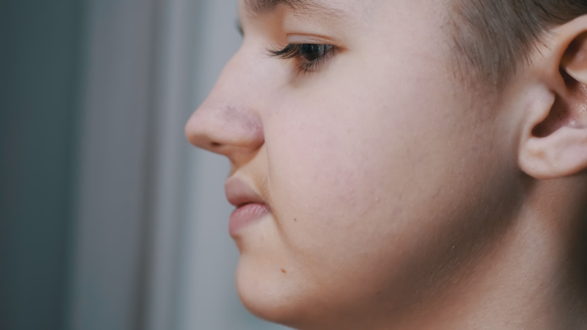 Face Profile of a Talking Displeased Teenager Moving his Lips. Close-up. Head of a child with long eyelashes, mustache. Part of the face. Conversation, behavior, emotions, mouth gestures. Side view. | Shutterstock HD Video #1091770391
