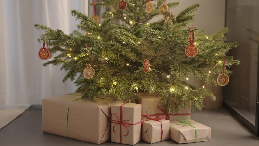 Slide shot shot of christmas tree with present boxes indoor with warm light | Shutterstock HD Video #1091771361