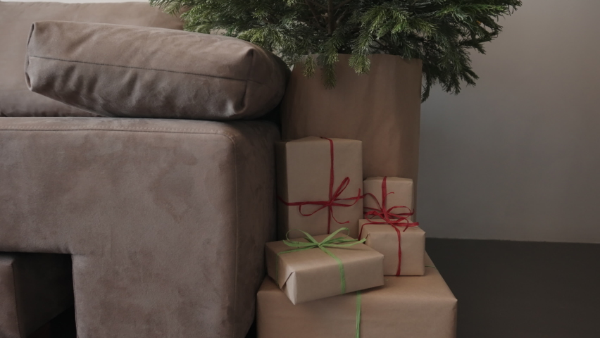 Slide shot of christmas gifts under spruce indoor with window light | Shutterstock HD Video #1091771401