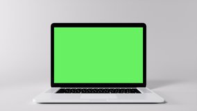 Green Screen Display Laptop Opens and Zoom In on a White Background. Empty Green Mock-up Monitor for Video Call, Website Template Presentation or Game Applications. Blank Screen Monitor 3D render