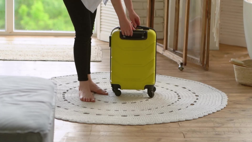Satisfied woman packed a suitcase for a trip