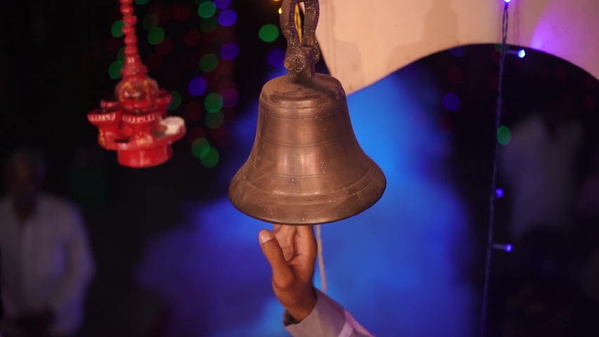Hindu Temple Ringer Bell Closeup | Brass made bell is being rang by a person | Indian religious background - Selective focus Royalty-Free Stock Footage #1091776773
