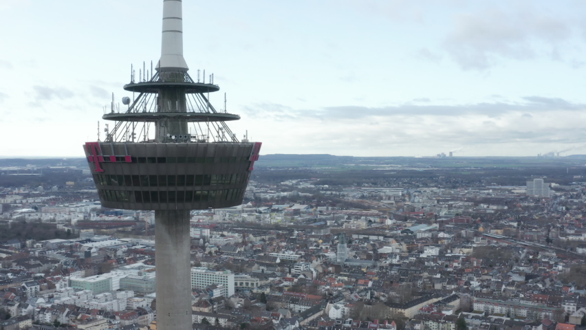 Orbit shot around platform on Colonius telecommunications tower with various antennas. Buildings in city in background. Cologne, Germany