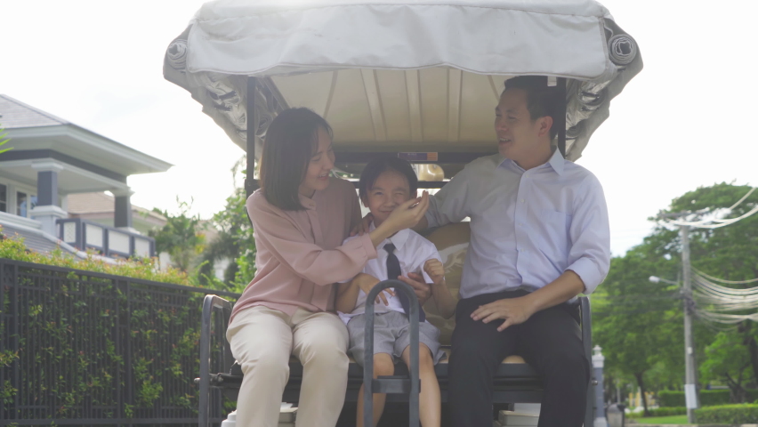 Portrait of happy smiling Asian Family living together on golf cart, in family relationship on vacation. Love of father, mother, and son. People lifestyle.