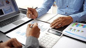 Business people pointing graph and using calculator during business meeting. Business team meeting and presenting business result discussion and analysis data chart and graph finance and accounting. - Powered by Shutterstock - Get 15% off with code: PIKWIZARD15