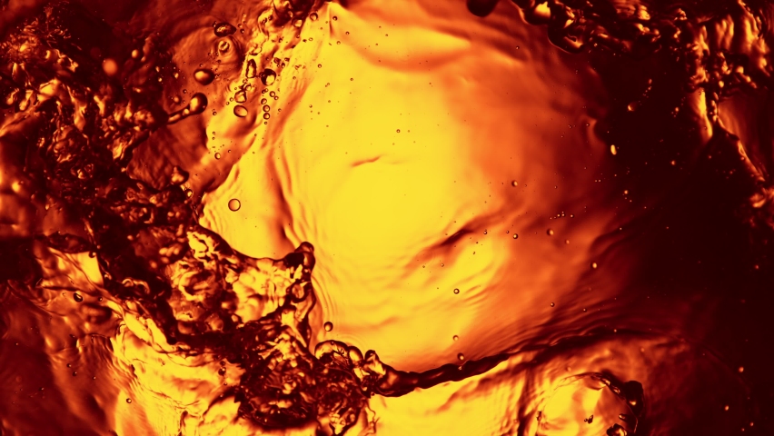 Super slow motion of splashing whiskey, cognac or oil surface. Filmed on high speed cinema camera, 1000 fps. Royalty-Free Stock Footage #1091784797