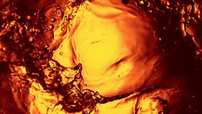 Super slow motion of splashing whiskey, cognac or oil surface. Filmed on high speed cinema camera, 1000 fps. - Powered by Shutterstock - Get 15% off with code: PIKWIZARD15