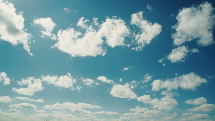 Clouds and blue sunny sky, Sunbeams shining through white fluffy clouds, View from the airplane window. Royalty-Free Stock Footage #1091787553