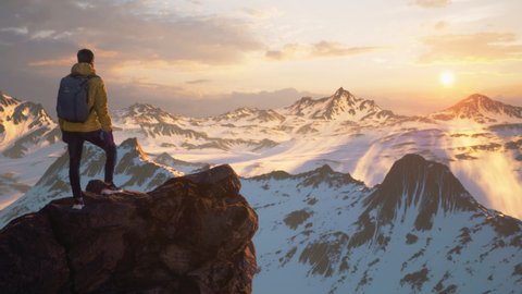 Стоковое видео: HIker Standing on Top of a Mountain Peak Looking at Sunset Adventure Spirit Success Nature Beauty Acheivement Freedom Exploration Alps