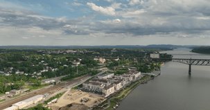 Summer afternoon aerial drone video of the Hudson River, Poughkeepsie, NY, walking bridge and Mid-Hudson Bridge of the Hudson River.. 