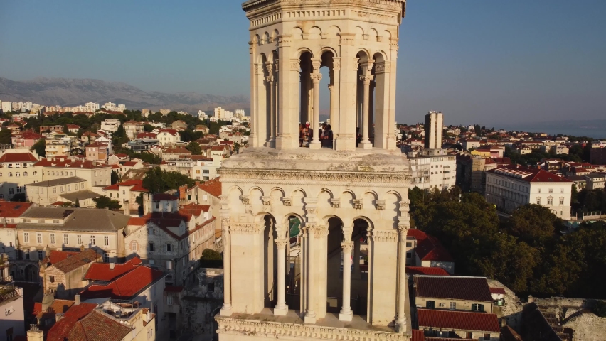 Aerial view of Croatian Catholic Cathedral bell tower. Panoramic view of Diocletian's Palace at sunset, Dalmatia, Croatia. Sunset in Split, high quality 4k footage.
 Royalty-Free Stock Footage #1091802301