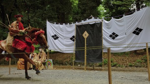 Otsu , Shiga , Japan - 06 10 2022: Mounted Samurai Archer Rides Past Target at Omi Jingu Shrine, Slow Motion 4k