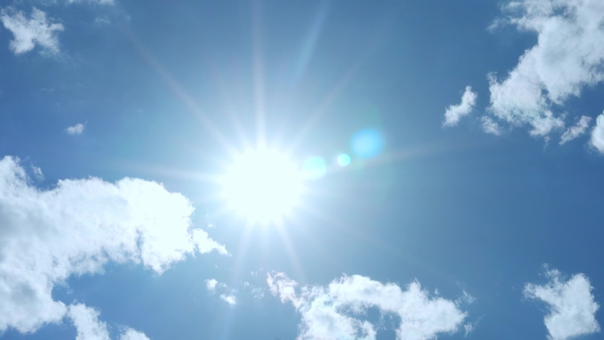 Bright Shining Sun, Macro, Clear Blue Azure Sky and Few White Fluffy Clouds on Clear Sunny Day, Timelapse. Time Lapse of Sun's Illumination in Clear Blue Summer Sunny Sky with Low Clouds.