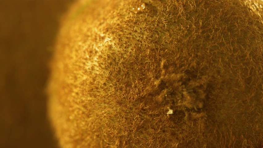 Rolling half of Gold Kiwi and opening the inside of the fruit in Slow motion. 4K