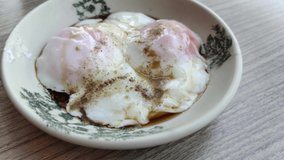 Close-up view two half boiled eggs served with soy sauce and white pepper. - Powered by Shutterstock - Get 15% off with code: PIKWIZARD15