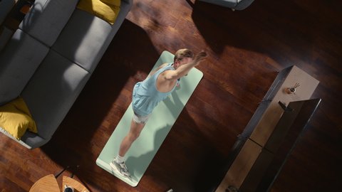 Top View Sport: Attractive Guy Doing Yoga Stretching on an Exericise Mat at Home. Muscular, Fit, Handsome Athletic Man Does Fitness Workout in His Apartment. Top Down Zoom Out Slow Motion Spin Shot
