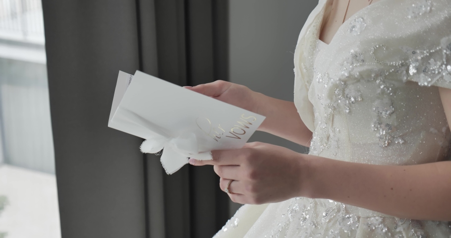 The bride in a luxurious wedding dress reads a letter | Shutterstock HD Video #1091817423