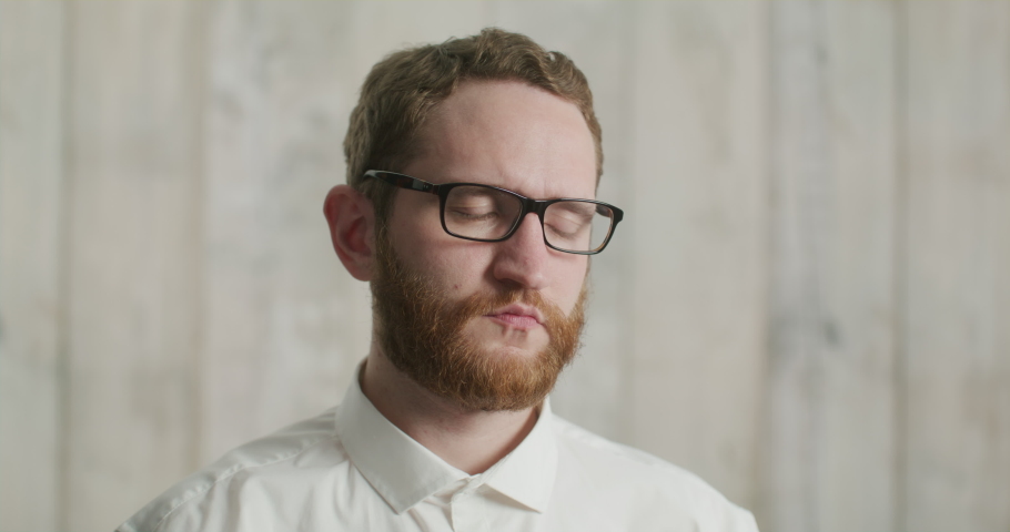 serious man with glasses and a headache. An office worker after a hard day. Portrait of a handsome bearded man with glasses rubbing his temples Royalty-Free Stock Footage #1091818367