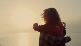 Playful woman and man dancing on beach at sunrise. Romantic couple hugging at sea shore. Happy girl and guy expressing feelings to each other. Young lovers spending time together. Lifestyle concept - Powered by Shutterstock - Get 15% off with code: PIKWIZARD15