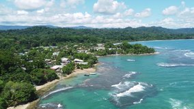 Puerto Viejo, Costa Rica: Aerial drone footage of the Puerto Viejo resort town, coastline and beach by the Caribbean sea in Costa Rica. Shot with a forward motion 