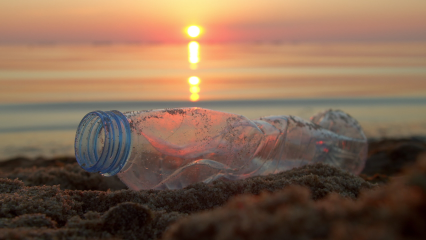 Volunteer cleans the beach from plastic bottles and various garbage on the seashore. Environmental awareness and volunteering, recycling concept. Royalty-Free Stock Footage #1091822073