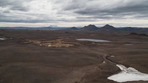 Aerial View Shot of car driving through volcanic land, picturesque view, Iceland