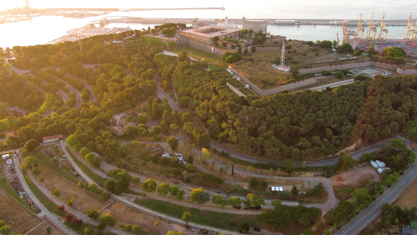 Aerial drone view of Barcelona, Catalonia, Spain. Montjuic Castle at sunrise, a lot of greenery, seaport on the background. Ancient fortification, a well-known landmark