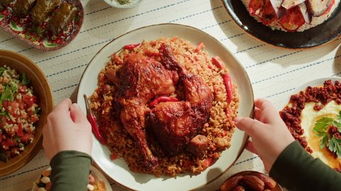 Kabsa top view, rice and meat dish, saudi arabia national traditional food. Muslim family dinner, Ramadan, iftar. Arabian cuisine. Religious holiday, holy month. 库存视频