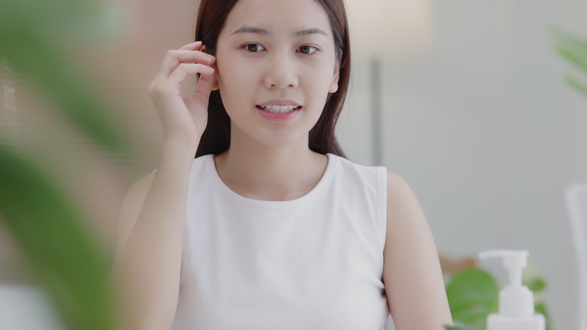 Beauty Face. Closeup headshot portrait of smiling Asian girl with natural makeup and healthy smooth skin looking at camera. Beautiful girl with hydrated facial skin. | Shutterstock HD Video #1091830731
