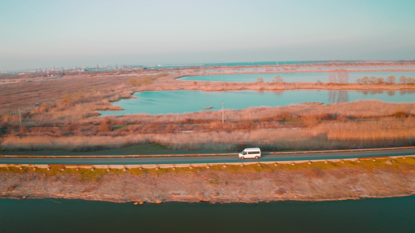 aerial drone fly over last lakes at sunset sky. Beautiful Ladscape view of Burgas Bulgaria at sunset. Beautiful teal color of water and orange sky