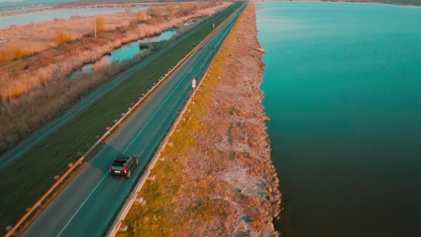 aerial drone fly over last lakes at sunset sky. Beautiful Ladscape view of Burgas Bulgaria at sunset. Beautiful teal color of water and orange sky