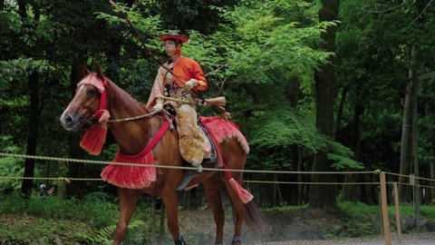 Otsu , Shiga , Japan - 06 12 2022: Japanese Samurai Archer on Horseback rides past at Yabusame Event