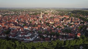 Aerial orbit of historical Nordlingen town centre at sunset, Bavaria Germany