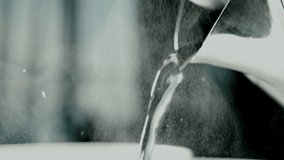 Slow motion hot water pouring from a teapot. Hot water is pouring from the kettle. 4K - Powered by Shutterstock - Get 15% off with code: PIKWIZARD15