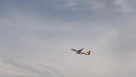 Istanbul, Turkey, 07.01.2022: Pegasus Airlines plane taking off, flying high on a cloudy grey day up in the sky. Commercial aviation. Economy cheap flying tickets. Short staff crises