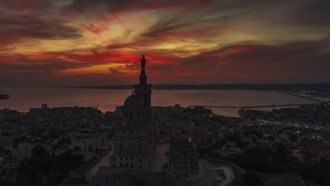 Establishing Aerial View Shot of Marseille Fr, Bouches-du-Rhone, Provence-Alpes-Cote d'Azur, France, Basilique Notre-Dame de la Garde, incredibly beautiful sunset, reveal shot