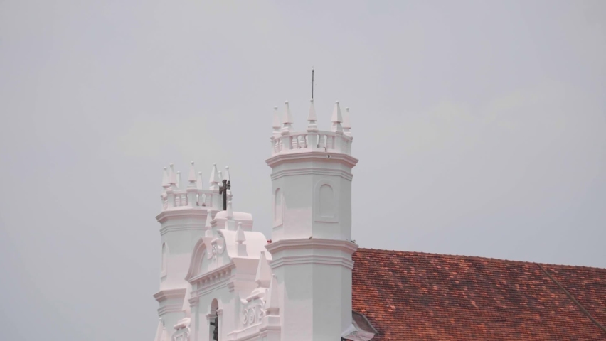Closeup shot of cross on the top of Catholic Church of St. Francis of Assisi at Goa in India. Church built by the Portuguese at Goa. Old and famous church of Goa. Cross on top of the catholic church.  | Shutterstock HD Video #1091847531