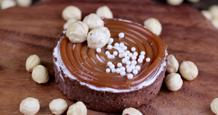 Spinning delicious tartlets with buttercream and caramel with nuts, fresh delicious cake spinning on the table | Shutterstock HD Video #1091850007