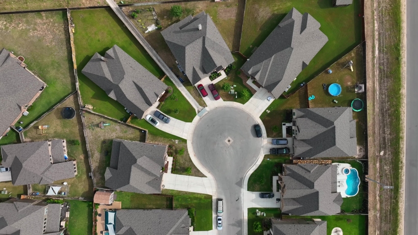 Top down aerial of rooftops of homes and swimming pools in modern American residential suburban community. Royalty-Free Stock Footage #1091856645