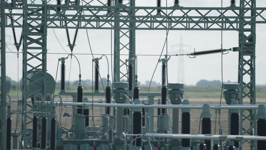 A close-up shot of an electrical power plant. Slow-motion, pan right
