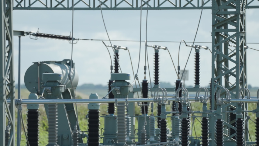 A close-up shot of an electrical power plant. Slow-motion, pan left.