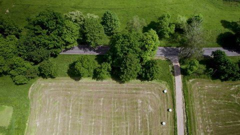 Aerial View Of Round Hay Bales In The Harvested Field.