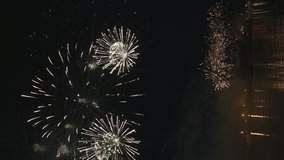 Vertical 4k footage of beautiful Fireworks on Deep Black Background Sky on Fireworks festival from sail yacht over night city lights in summer river night trip. High quality 4k raw video - Powered by Shutterstock - Get 15% off with code: PIKWIZARD15